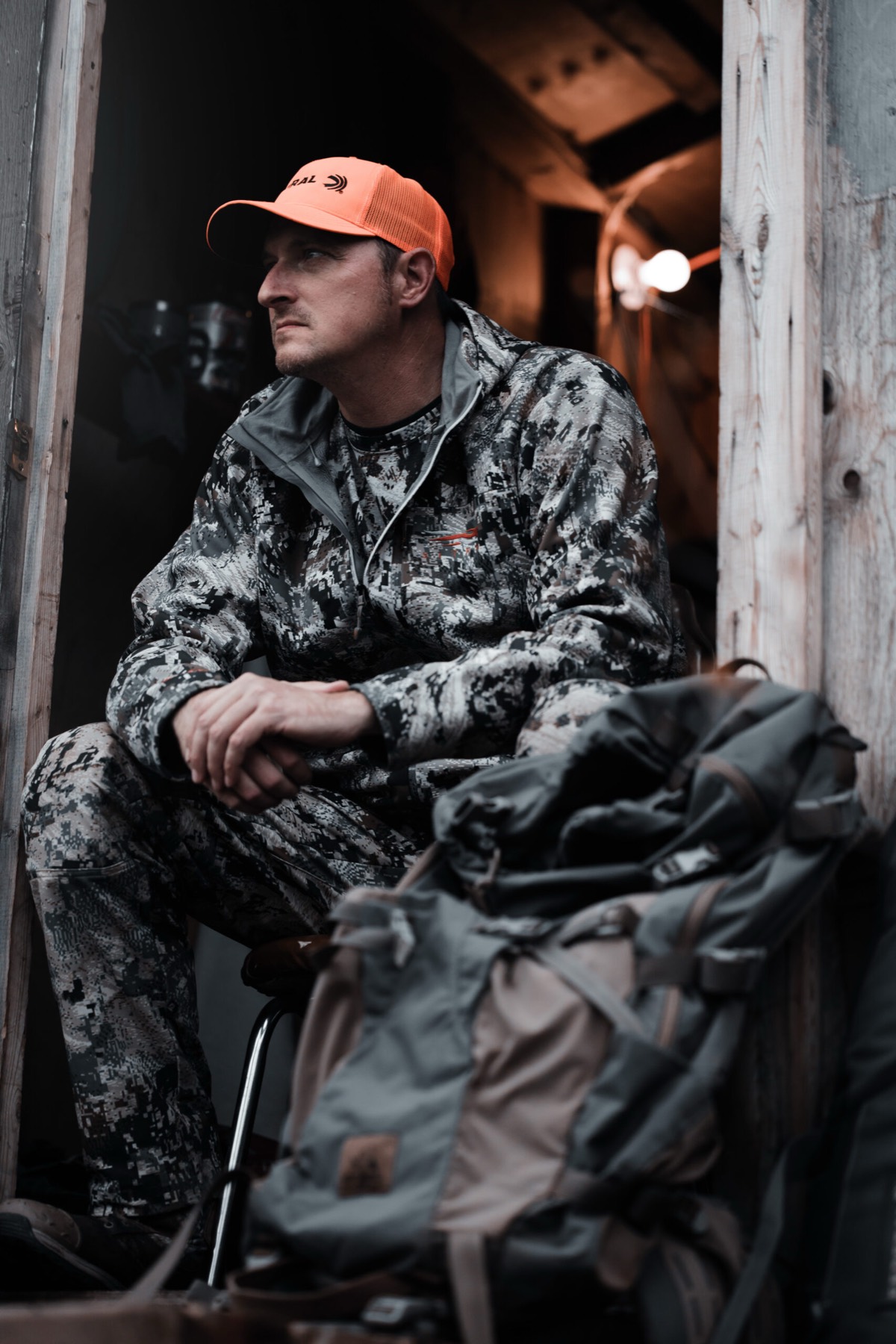 Hunter resting in a cabin doorway