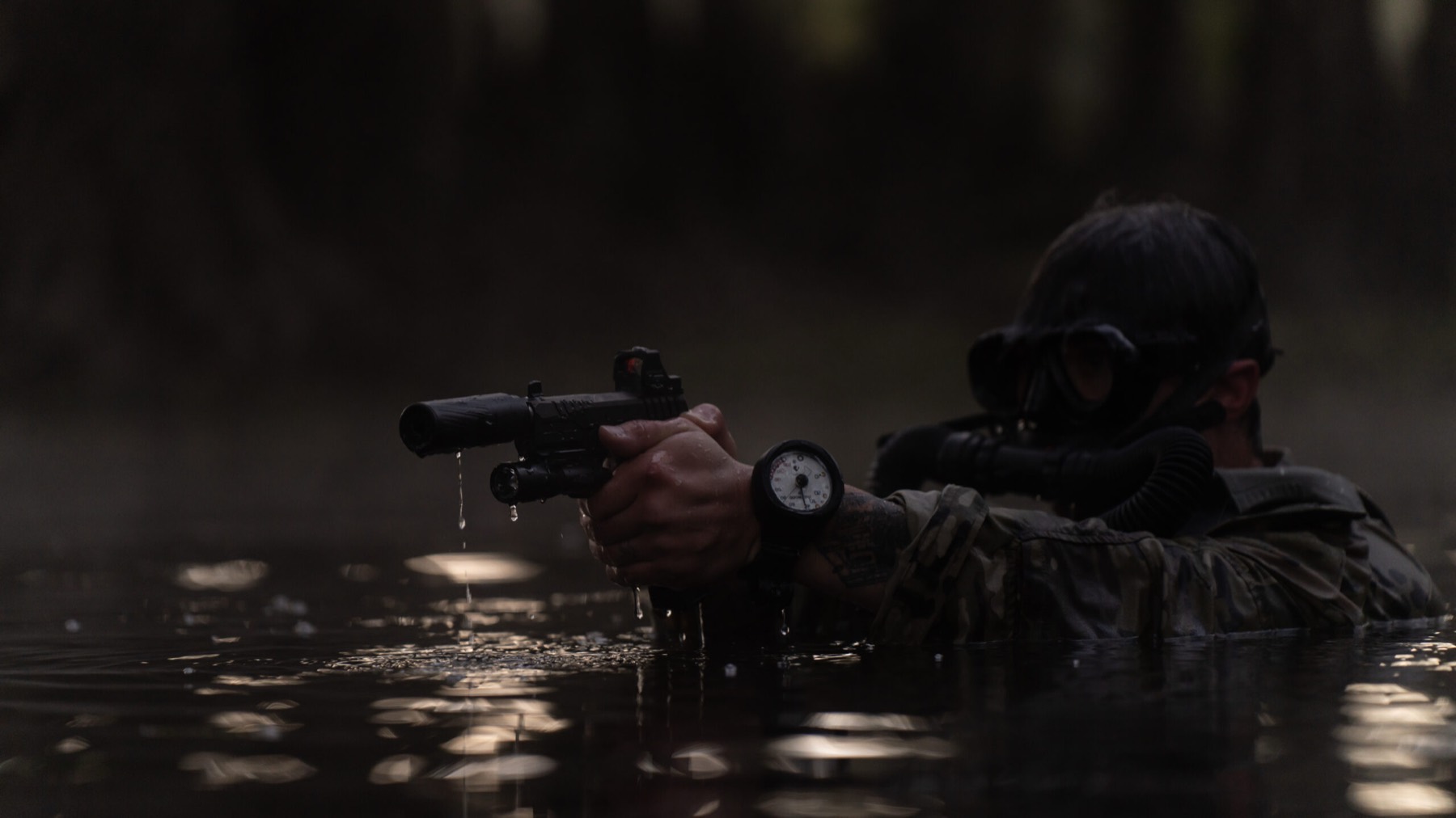 Operator in dark water with pistol