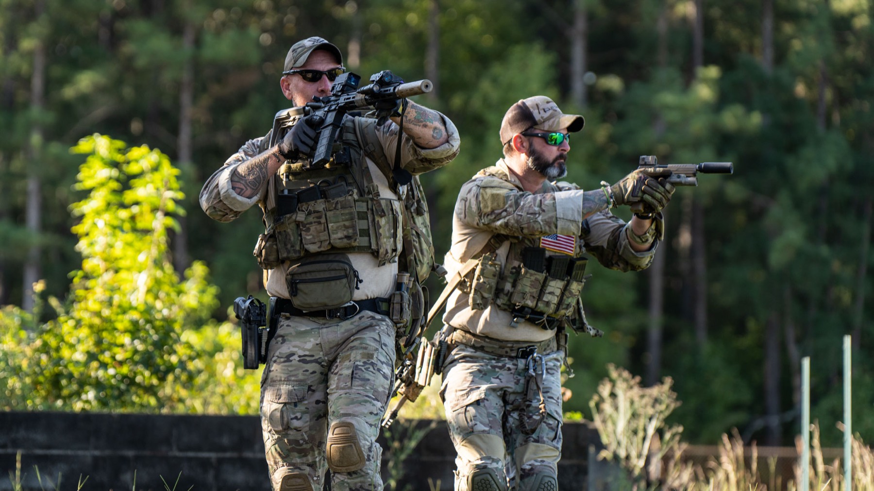 Two shooters moving through a training course