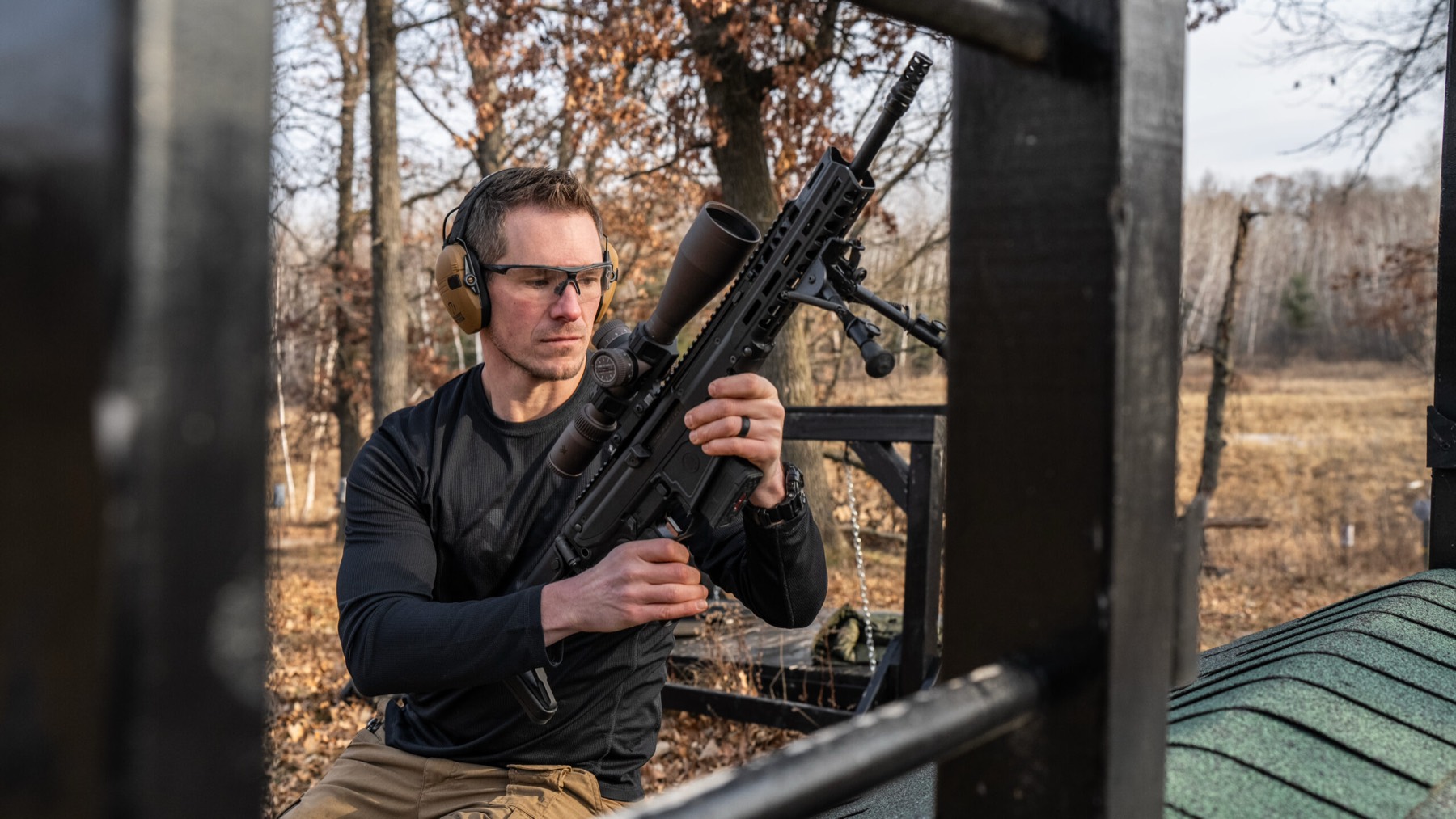 Shooter loading rifle at the range